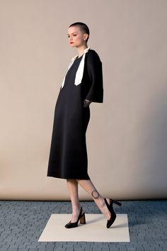 "With this beautiful Minimalist Dress we introduce our fashion for Spring 2019 ! This stylish black dress is cut in the the brand's most recognizable silhouette - the laid-back approach to elegance. The design has straight, elegant silhouette - it is our go-to for effortless, easy-to-wear pieces. Wear your occasion dress with sandals, high heels, ballerinas. ITEM DETAILS: - straight line - side pockets - shoulder bow decorations - custom orders: yes - color: black and creamy COMPOSITION AND CARE Black A-line Dress For Office Wear, Black Office Lady Midi Dress For Party, Black Sheath Office Dresses, Black Midi Dress For Office Party, Black Sheath Dresses For Office, Sheath Dress For Night Out, Office Lady Style, Modern Black Mini Dress For Workwear, Office Lady Black Midi Dress For Work, Black A-line Dress For Work