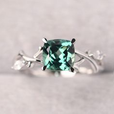 ◆ The ring is handcrafted from sterling silver and decorated with a dazzling 7*7 mm Lab green sapphire and marquise cut cz. It is suitable for engagement/anniversary/daily occasion. ◆ Production Description: Main stone Type: Lab green sapphire Main Stone Shape: Cushion Cut Main Stone Size: 7x7 mm(1.96 ct) Side stone: Marquise cut cz Metal: 925 Sterling silver - Other options available in the drop down menu ◆ Customization: √Free for Add Engraving  √Other Metal Type Available √Other Gemstones & S Elegant Green Topaz Ring In Sterling Silver, Green Marquise Diamond Promise Ring, Green Marquise Brilliant Cut Rings, Green Sapphire Rings With Prong Setting, Green Sapphire Ring With Halo Setting For Promise, Green Sapphire Rings With Halo Setting, Green Sapphire Jewelry With Halo Setting, Green Marquise Emerald Ring For Anniversary, Green Round Topaz Ring For Anniversary