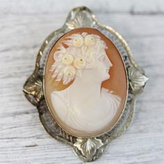 HERE ARE THE DETAILS YOU NEEDN5997Antique 14K White Gold Carved Shell Cameo Brooch Filigree Pendant Lady LuxuryBEAUTIFUL LADY W/ FLOWERS. HAND CARVED SHELL. FINEST DETAIL AMAZING BROOCH PIN WONDERFUL HIGHEST QUALITY. JUST PART OF MY MOST RECENT ESTATE FINDS! FOLLOW ME TO SEE THEM ALL! Metal Purity: Metal: 14K White GoldMaterial: Carved Shell CameoForm: Brooch Filigree Pendant Lady LuxurySize :1 5/8 x 1 3/8"Age: AntiqueWeight (Grams): 7.6IT IS IN VERY FINE ESTATE CONDITION           ALL ITEMS LIS Vintage White Gold Oval Brooches, Formal Engraved Brooches, Lady Luxury, Cameo Jewelry, Filigree Pendant, Vintage Cameo, Antique Brooches, Carved Shell, Gold Necklace Set