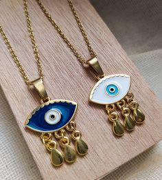 evil eye necklacefortune tellergood luck necklaceevil eye gold charmevil eye golddainty gold necklacegold eye pendantgifts for herdainty necklaceDelicate NecklaceBirthday giftgold necklacelayered necklace Evil eye charm pendant is made of 24k gold plated steel and is handpainted! Customize your necklace by choosing the length of it (35 - 85 cm) and between 2 Evil eye colors! Everything is handmade from the scratch with love and care. All the parts are waterproof,nickel free and antiallergic . Ev Spiritual Gold Eye-shaped Necklace, Gold Evil Eye Pendant Charm Necklace, Gold-plated Evil Eye Amulet Necklace, Gold Evil Eye Amulet Jewelry, Dainty Evil Eye Jewelry For Good Luck, Dainty Gold Eye-shaped Jewelry, Gold Plated Evil Eye Pendant Charm Necklace, Gold Plated Evil Eye Charm Necklace Gift, Gold Evil Eye Pendant Jewelry