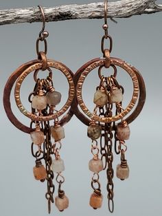 Rough cut 4mm warm, orangey-peach faceted cube beads drip from hammered and oxidized copper hoops to create this beautiful pair of rustic earrings. Simple hypoallergenic ear wires. Length (from ear wire): 2.5 Inches Width: 1 inch Hoop Earrings Handmade, Rustic Earrings, Sell Gold, Argentium Silver, Wire Earrings, Silver Hoops, Silver Hoop Earrings, Stone Earrings, Jewelry Plate