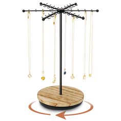 a jewelry stand with several necklaces hanging from it's sides and an arrow pointing to the top