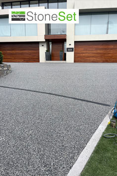 a man with a hose in front of a large building that has stone set written on it