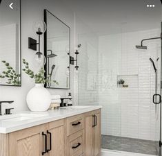 a bathroom with two sinks and mirrors on the wall