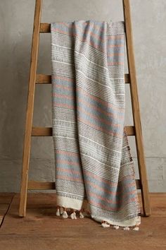 a ladder leaning against a wall with a blanket on it