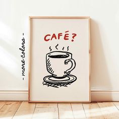 a coffee cup with the words cafe written on it in front of a white wall