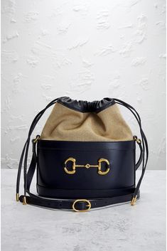 Find GUCCI Horsebit 1955 Bucket Bag on Editorialist. This Gucci Horsebit 1955 Bucket Bag is crafted from calf leather. It features gold-tone hardware, a drawstring closure, one main compartment with a single slip pocket, and an adjustable shoulder strap with a 19 to 22 inch drop. It measures approximately 9 inches wide, 10 inches high, and 5 inches deep. The bag includes an original dust bag and care booklet. The bag shows signs of moderate to significant wear, including scratches and rubbing on Designer Gucci Bucket Bag For Evening, Gucci Bucket Bag With Leather Handles, Designer Gucci Bucket Bag With Removable Pouch, Gucci Luxury Bucket Bag For Daily Use, Daily Use Gucci Luxury Bucket Bag, Daily Use Luxury Gucci Bucket Bag, Gucci Leather Bucket Bag, Chic Gucci Bucket Bag With Removable Pouch, Chic Gucci Bucket Bag For Evening