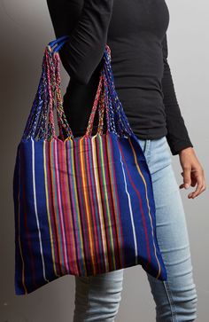 Experience the vibrant spirit of Chiapas with this handcrafted Hammock Bag, woven by skilled artisans on a traditional loom. Each bag features rich, colorful patterns that add a touch of Mexican artistry to any outfit or home decor. Perfect for carrying essentials, as a stylish beach bag, or even as a unique storage solution, this versatile bag seamlessly blends function with cultural flair. Elevate your style and space with the timeless beauty of this handmade Chiapas creation. 16” x 26” (inclu Artisan Blue Handwoven Bags, Artisan Multicolor Beach Bag For Travel, Handwoven Hobo Tote Bag For Market, Blue Bohemian Woven Crochet Bag, Artisan Blue Handwoven Shoulder Bag, Blue Artisan Handwoven Shoulder Bag, Artisan Handwoven Blue Shoulder Bag, Bohemian Blue Woven Crochet Bag, Blue Bohemian Crochet Woven Bag