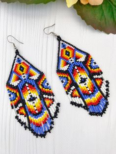 Handmade Multicolor Tassel Drop Earrings, Traditional Handmade Multicolor Tassel Earrings, Blue Southwestern Beaded Fringe Earrings, Southwestern Blue Beaded Fringe Earrings, Southwestern Beaded Earrings With Tassels For Festival, Multicolor Tassel Earrings For Festival, Multicolor Handwoven Bohemian Earrings, Festival Multicolor Beaded Fringe Chandelier Earrings, Traditional Colorful Beaded Earrings For Festival