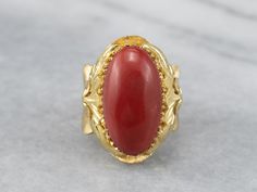 This is a beautiful, Victorian-inspired piece! Organic forms of textured 18k gold frame the deeply saturated coral, while the multi-prong setting holds the cabochon safely in place. The polish on this sumptuous coral is excellent, and makes this ring elegant enough for evening wear! Metal: 18K Yellow Gold Gem: Coral Gem Measurements: 19.4 x 10.4 mm, Oval Ring Size: 6.75 Marks: "750" Stamped on the inside band Unique Cabochon Ruby Ring For Formal Occasions, Elegant Red Dome Ring For Formal Occasions, Elegant Coral Rings For Anniversary, Formal Coral Jewelry With Cabochon Details, Formal Coral Jewelry With Cabochon, Coral Elegant Wedding Rings, Elegant Coral Wedding Rings, Red Coral Ring, Ring Elegant