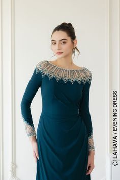 This elegant evening dress features a boat neck and long sleeves, perfect for a sophisticated look. The intricate beading adds a touch of glamour to any special occasion. Made with high-quality materials for a luxurious feel.