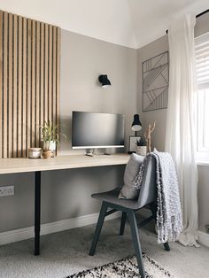 a desk with a computer on it in a room