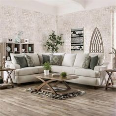 a living room with white couches and wooden tables in it's center area