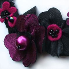 Pink and black fabric flowers combine beautifully on this elegant ribbon necklace. The dark magenta shines against the black on this stylish statement necklace. This really is a piece of special occasion jewellery which would be wonderful for a big night out or an exceptional day. For instance, a pink and black wedding can be a chic affair. These colours contrast beautifully against a backdrop of white. This fancy necklace is glamorous, striking and feminine so it would be perfect of this event. Black Ribbon Necklace For Party, Handmade Flower Necklaces For Party, Party Necklaces With Handmade Flowers, Black Flower Necklace For Party, Pink Handmade Flowers Necklace For Party, Black And Pink Wedding, Bright Pink Wedding, Fabric Brooches, Magenta Fabric