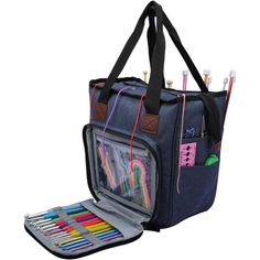 an open bag with pens, pencils and markers in it on a white background