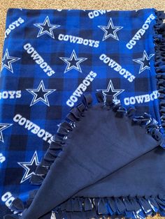 Great for any Dallas Cowboys fan. Has a solid dark blue back.  Handmade fleece tie blanket that is very soft to cozy up with. 65in by 52in  *This blanket is made from licensed material, however it is not a licensed product nor I am affiliated with the licensee.** Dallas Cowboys Blanket, Fleece Tie Blanket, Cowboys Dallas, Tie Blanket, Fleece Tie Blankets, Throw Pillow Set, Tie Blankets, Dallas Cowboy, Grill Apron