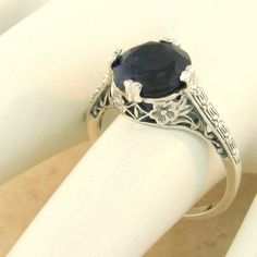 Vintage Estate 2 Carat Simulated Sapphire Solitaire Filigree Ring. 925 Solid Sterling Silver. The Top Of The Ring Measures 3/8 Inches In Length. Stamped 925. Excellent Condition/Like New. Classic Round Sapphire Ring For Formal Occasions, Elegant Filigree Solitaire Ring For Formal Occasions, Formal Solitaire Sapphire Ring, Elegant Sapphire Ring With Round Cut For Wedding, Victorian Sterling Silver Wedding Jewelry, Elegant Solitaire Filigree Ring For Anniversary, Antique Wedding Rings With Round Stone, Victorian Silver Engraved Ring For Formal Occasions, Classic Round Sapphire Wedding Ring