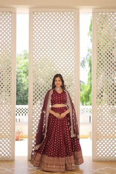 Wine Dyable Viscose Jacquard Lehenga Set is perfect for any occasion. The double zari work in the flair adds a touch of elegance, making it ideal for weddings, festivals, and other special events.  Highlights: Lehenga: Crafted from Pure Dyable Viscose Jacquard, this stitched lehenga offers a luxurious texture and a rich wine color. With a length of 42 inches and a 3.5-meter flair, it creates a graceful silhouette. The cotton inner lining ensures comfort, while the chain closure with dori latkan adds a traditional and secure fit. The stitching with can-can and canvas-patta enhances its structure and elegance. Blouse: The set includes a matching stitched blouse made from Dyable Pure Viscose Jacquard, measuring 1 meter in length. It complements the lehenga, allowing you to create a harmonious Luxury Jacquard Dupatta With Zari Work, Luxury Jacquard Wedding Dupatta, Luxury Jacquard Dupatta For Wedding, Luxury Traditional Jacquard Dupatta, Jacquard Lehenga, Stitched Lehenga, Zari Work, Wine Color, Festival Wedding