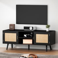 an entertainment center with a flat screen tv and speakers