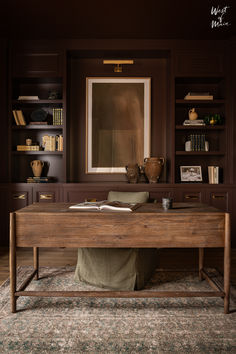 a wooden table sitting in front of a bookshelf