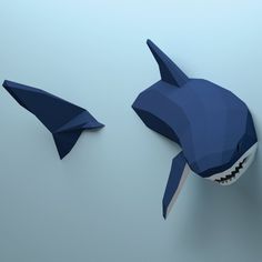 an origami shark and a shark fin are shown in low polygonics