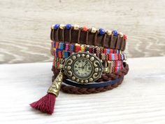 Bohemian watch bracelet Colorful wristwatch Wrap Boho watch Multicolor Boho Watch for Woman gift Boho Rainbow Watch Brown Red Watch  Bohemian watch bracelet with a colorful textile band and quartz mechanism. This wrap boho watch can be worn as a spectacular boho jewelry. A perfect gift for a friend or for the woman you love. It has two separate bracelets to the watch: - the first bracelet is made from a brown suede band, brown cotton cord, and blue, red, and gold glass beads - the second one is made from brown and dark blue suede cord You can order wristwatch only or wristwatch and one or the two bracelets as follow: - All Set - you will receive the wristwatch and the both bracelets - Wristwatch only - you will receive the wristwatch only - Watch+Beads Bracelet - you will receive wristwatc Adjustable Bohemian Style Watches As Gift, Bohemian Style Adjustable Watches As Gift, Multicolor Analog Watches As Gift, Multicolor Analog Watches For Gift, Gift Multicolor Analog Watches, Bohemian Bracelet Strap Watch Accessories As Gift, Bohemian Watch Accessories With Bracelet Strap As Gift, Multicolor Bracelet Strap Watch As Gift, Multicolor Watches With Bracelet Strap As Gift