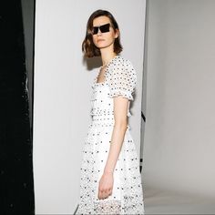 Via Matchesfashion Self Portrait's White Midi Dress Is Framed In Heavyweight Hibiscus-Patterned Guipure Lace And Exudes The Label’s Contemporary Femininity. It's Designed With A Square Neckline With Gathered Cuffs Reminiscent Of 19th Century Silhouettes And Leads Down To A Semi-Sheer Panel On The Box Pleat Skirt. Team It With Bright Accessories For Garden Parties. Shown Here With By Far Annie Crocodile-Effect Leather Bag, Wandler Square Leather Mules And Alighieri 24kt Gold Necklace. White Midi Dress For Summer Evening, Designer Summer Evening Midi Dress, White Midi Dress For Summer Cocktail, White Midi Dress For Summer Cocktail Events, Designer Summer Midi Dress, White Broderie Anglaise Midi Dress For Summer, Chic White Midi Dress With Broderie Anglaise, Designer White Party Dress, Designer White Spring Dresses