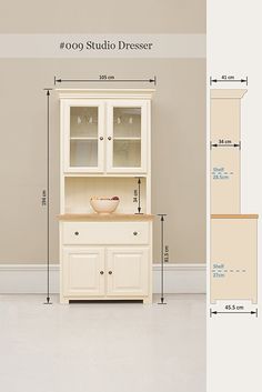 the measurements for a white china cabinet in a room with beige walls and flooring