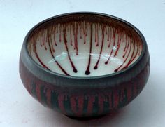 a white and red bowl sitting on top of a table