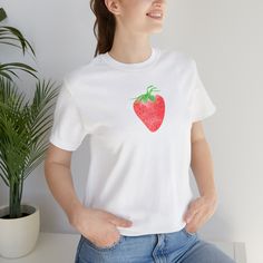 Delicious and Sweet, the strawberry has been tingling us all of our lives. Represent the mightiest of fruity snacks. This classic unisex jersey short sleeve tee fits like a well-loved favorite. Soft cotton and quality print make users fall in love with it over and over again. These t-shirts have-ribbed knit collars to bolster shaping. The shoulders have taping for better fit over time. Dual side seams hold the garment's shape for longer.  .: 100% Airlume combed and ringspun cotton (fiber content Cotton T-shirt With Strawberry Print, Cotton Short Sleeve T-shirt With Strawberry Print, White Relaxed Fit T-shirt With Strawberry Print, Casual White T-shirt With Strawberry Print, White Crew Neck T-shirt With Strawberry Print, White Strawberry Print Graphic Tee, Red Short Sleeve T-shirt With Fruit Print, Strawberry Print Cotton T-shirt With Short Sleeves, Casual Red T-shirt With Fruit Print