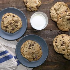 chocolate chip cookies on blue plates with milk and napkins next to eachother