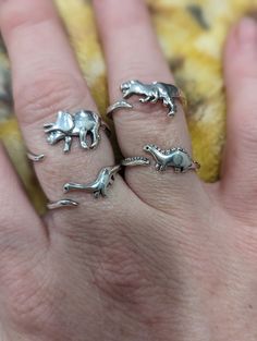 RAWR!  Introducing our stylish and unique adjustable dinosaur fashion rings, the perfect accessory for any occasion! Crafted with attention to detail, this elegant piece features an intricate design that wraps around your finger, adding a touch of sophistication to your look. Made from high-quality materials, it's durable and comfortable to wear.  Treat yourself or surprise a loved one with this timeless accessory that is sure to add a unique twist to your everyday style. Order yours today and e Dinosaur Fashion, Dinosaur Rings, Dinosaur Ring, Handmade Fashion Jewelry, Skin Discoloration, Handcrafted Rings, Unisex Jewelry, Timeless Accessories, Handmade Fashion