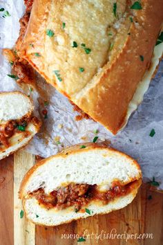 two slices of bread with meat sauce and cheese on them sitting next to each other