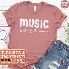 This stylish T-shirt and cozy sweatshirt feature the uplifting message "Music is always the answer". Perfect for music lovers, this comfortable apparel is great for casual wear or as a thoughtful gift. Let everyone know that music is your ultimate solution with this unique design! ❤️ HOW TO ORDER ❤️ 1. Check out all the photos for sizing and color options.📏 2. Choose your perfect size and color from the drop-down menus!✨ 3. Click "ADD TO CART" and feel free to add as many as you wish! 🛒 4. Hit "PROCEED TO CHECKOUT" and get ready to enjoy your awesome purchase! We will process your order and it will be ready for shipment in 1-5 days!🚀 5. Want this design on another product or want to make slight alterations? Check the bottom of the description.✨ 🎁 UNISEX T-SHIRTS 🎁 Brand: Bella Canas 3 Music-themed Slogan Crew Neck Top, Music-themed Slogan Tops With Crew Neck, Music-themed Slogan Top With Crew Neck, Music-themed Cotton Tops With Slogan, Music-themed Cotton Slogan Tops, Music-themed Relaxed Fit T-shirt With Letter Print, Music-themed Cotton Crew Neck Sweatshirt, Music-themed Cotton Sweatshirt With Letter Print, Music-themed Cotton Graphic Sweatshirt