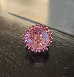 Beautiful Geometric carved amethyst surrounded by pink garnets. Rose Gold over sterling silver. Luxury Multi-stone Pink Gemstones, Luxury Pink Multi-stone Gemstones, Luxury Pink Gemstones For Wedding, Luxury Pink Gemstone With Center Stone, Luxury Pink Topaz Round Ring, Elegant Pink Ruby Gemstones, Luxury Pink Multi-stone Sapphire Ring, Pink Gemstones For Formal Fine Jewelry, Pink Gemstones For Formal Occasions