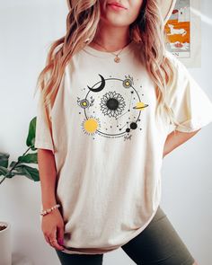 Looking for a shirt that celebrates the celestial realm? Look no further than our Comfort Colors celestial shirt! This stylish shirt features a beautiful astrological design and would make the perfect gift for the spiritual person in your life! Comes in multiple colors! Check out more designs here: www.etsy.com/shop/jadeandroseshop ✨️SIZE AND FIT: Your shirt will be printed on a high-quality, soft and comfortable unisex t-shirt. Sizes run true to size, which takes the guesswork out of ordering. Celestial Cotton Tops For Summer, Celestial Style Graphic T-shirt For Summer, Celestial Graphic Print T-shirt For Summer, Celestial Crew Neck Tops For Summer, Celestial Graphic Print Short Sleeve T-shirt, Celestial Style Graphic Print Short Sleeve T-shirt, Celestial Graphic Print Summer Tops, Celestial Graphic Print Crew Neck Top, Celestial Short Sleeve Tops With Moon Print