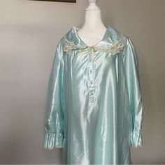 Ilise Steven’s Vintage Floor Length Nightgown With Lace Trim. Original Tags Attached. The Tag Reads Mint But The Color Can Also Be Described As Seafoam Green Or Ice Blue. Partial Button Down. Fold Down Quilted Collar Is Scalloped In The Back. 83% Polyester. 17% Cotton. Size Large. Please Note This Is A Vintage Item And Does Show Signs Of Wear. There Is One Discoloration On The Inside Lining Near The Tag. There Is Also Some Yellowing To The Lace. Please You Photos. Approximate Measurements: 55 In Long-sleeve Satin Nightgown For Sleepovers, Long Sleeve Satin Nightgown For Sleepovers, Satin Long Sleeve Nightgown For Sleepover, Blue Satin Sleepwear For Pajama Party, Blue Long Sleeve Nightgown For Pajama Party, Vintage Satin Nightgown For Sleep, Light Blue Long Sleeve Nightgown, Light Blue Long Sleeve Nightgown For Sleep, Light Blue Long Sleeve Nightgown For Bedtime