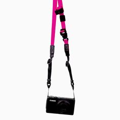 a camera strap attached to a black and pink digital camera on a white background with clippings