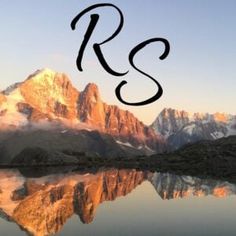 the letters r and s are in front of a mountain range with water below it