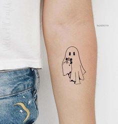 a woman's arm with a tattoo on it that has a ghost holding flowers