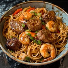 a close up of a bowl of food with noodles and meat on the side,