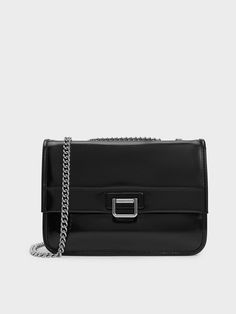 This product is made with at least 20% sustainable materials by weight. CHARLES & KEITH uses recycled, degradable, organic, and water-based materials in our eco-conscious collection.An elevated take on the classic satchel style, this Neva shoulder bag is the perfect everyday companion. The minimalist front-flap silhouette is punctuated by a silver-toned push-lock closure, which acts as both an elegant adornment and practical security feature at the same time. In sleek black, the luscious finish Bags Shop, Charles Keith, Online Bags, Clothes Gift, Kids Gifts, Women's Bags, Chain Strap, Trending Shoes, Bag Sale