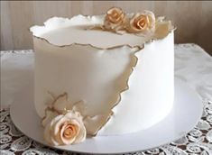 there is a white cake with flowers on it