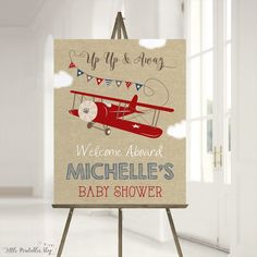 a welcome sign for a baby shower with an airplane