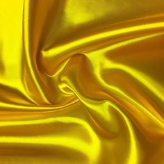 a close up view of a shiny yellow fabric