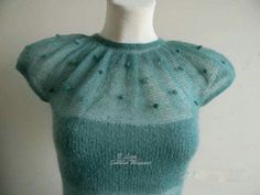 a knitted sweater on a mannequin's head