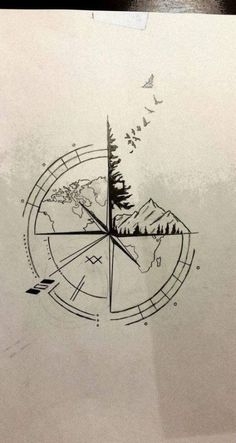 a compass tattoo on the side of a paper with trees and mountains in it,