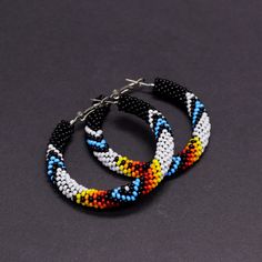 Black Native Americans inspired beaded hoop earrings. Absolutely eye-catching and very stylish - these earrings make a statement! Will go with any outfit, anytime, anywhere! These earrings are made of Czech seed beads and metal hoops. Hoops are approximately 2" (5cm) in diameter These earrings, whilst large, are lightweight and easy to wear. The hoops have a hinge fastening. The closure allows for peace of mind that you'll never lose an earring whilst it's being worn. A wonderful gift for her on Handmade Bohemian Hoop Beaded Bracelets, Bohemian Adjustable Hoop Earrings With Black Beads, Adjustable Bohemian Hoop Earrings With Black Beads, Bohemian Hoop Earrings With Black Beads, Unique Beaded Hoop Earrings For Festivals, Beadwork Designs, Beaded Earrings Diy, Native Style, Beadwork Patterns