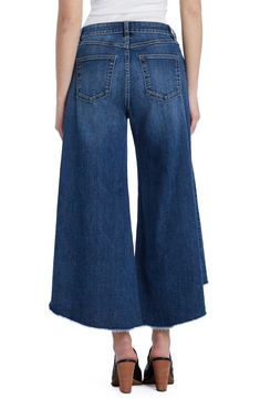 Pronounced distressing dances along the hem of these sweeping gaucho jeans cut from stretch-kissed denim with a heavily sanded finish. 24" inseam; 28" leg opening; 10 1/4" front rise 66% cotton, 22% REPREVE® recycled polyester, 8% polyester, 3% rayon, 1% spandex REPREVE recycled polyester is made from 100% post-consumer recycled plastic bottles Machine wash, tumble dry Imported Fall Wide Leg Cropped Jeans With Frayed Hem, Wide Leg Cropped Jeans With Frayed Hem For Fall, Chic Cropped Jeans With Frayed Hem In Dark Wash, Denim Blue Cropped Jeans With Frayed Hem For Fall, Fall Cropped Denim Blue Jeans With Frayed Hem, Fall Flare Jeans With Frayed Hem In Denim Blue, Fall Denim Blue Flare Jeans With Frayed Hem, Wide Leg Flare Jeans With Frayed Hem For Fall, Fall Flare Jeans With Frayed Hem And Wide Leg