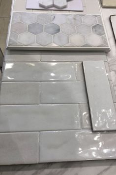 the counter top is white and has different tile designs on it, including hexagonal tiles